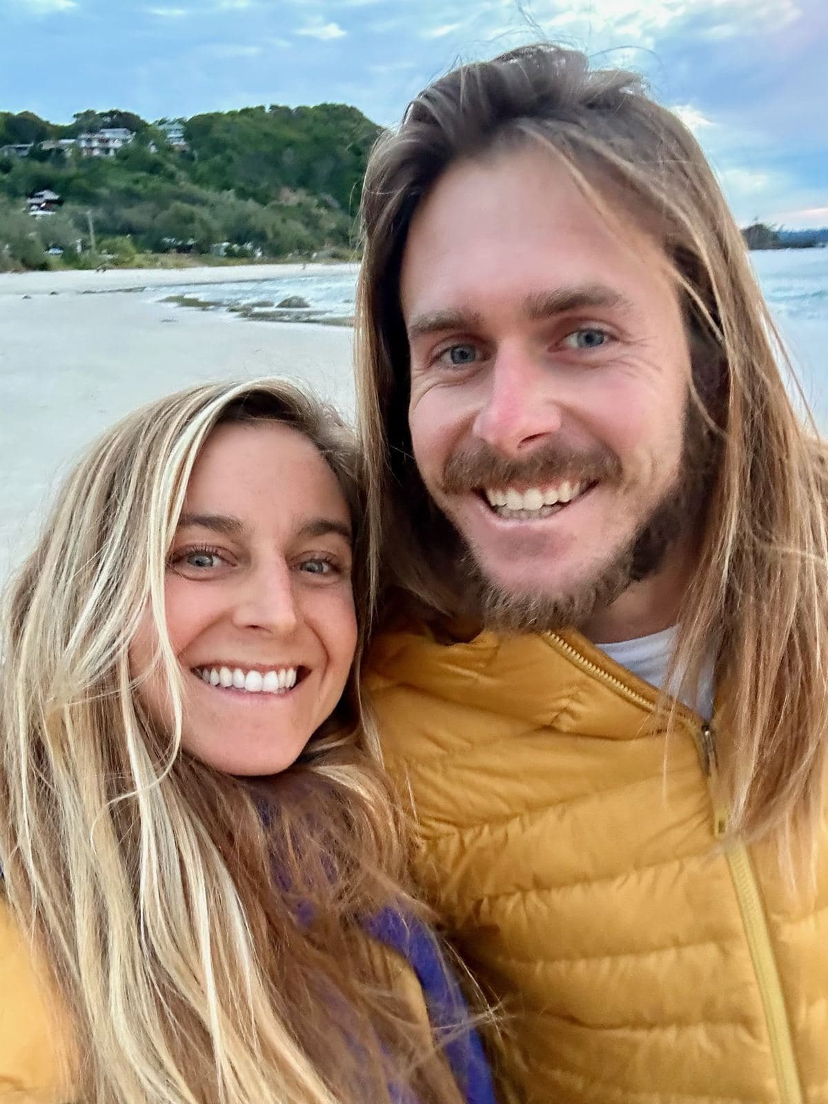 Cody and Falyn on the beach in puffer jackets
