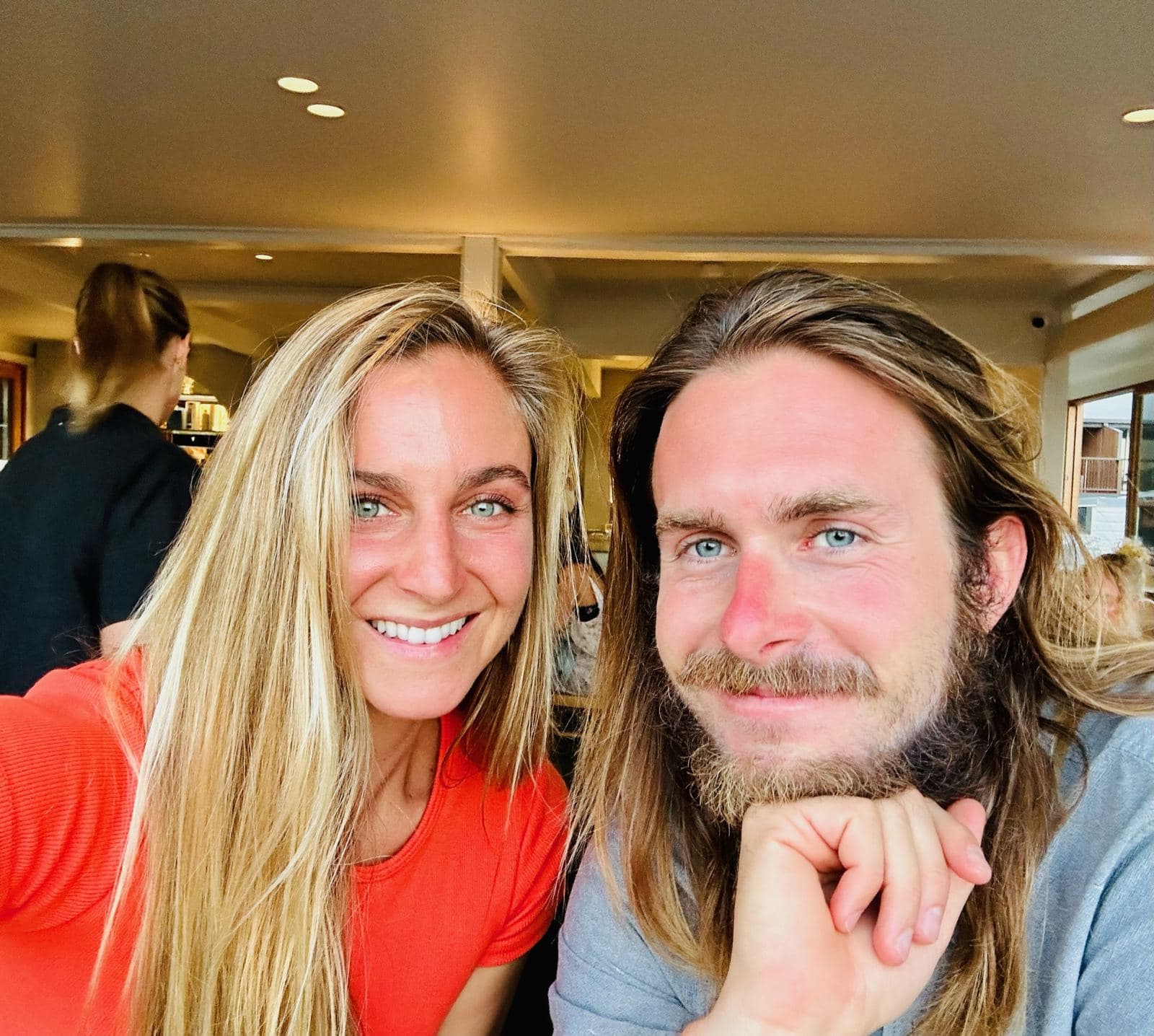 Cody and Falyn at a restaurant, both beaming