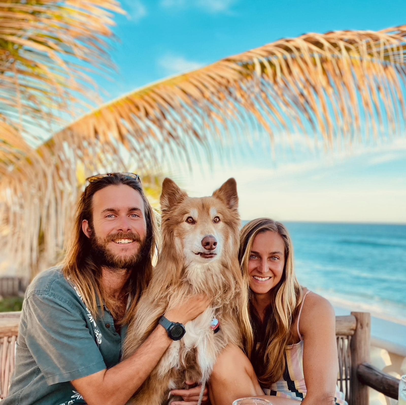 Cody and Falyn on a beach terrace with Captain between them