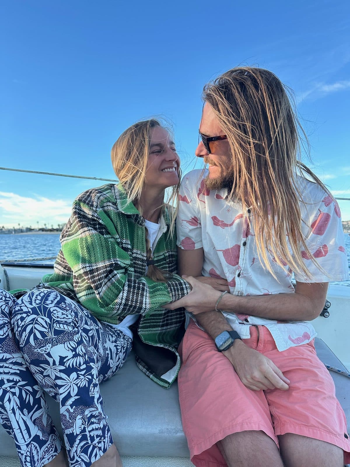 Falyn and Cody leaning in close on a sailboat